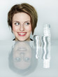 Photo: Pretty woman looking at a lot of silver coins is very happy Pretty woman looking at a lot of silver coins is very happy