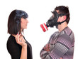 man with gas mask protects against tobacco smoke