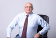 portrait of a successful senior man on gray background