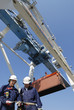 container port, trucks, cranes and workers container port, trucks, cranes and workers