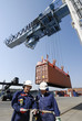 container port, trucks, cranes and workers