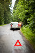 Young female driver calling the roadside service