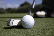 Close up of golf ball and putter on the putting green Close up of golf ball and putter on the putting green