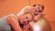 Women relaxing on gym ball