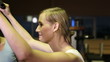 Woman with fitness trainer on lat machine