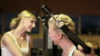 Fitness trainer helping woman on lat machine