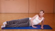 Woman stretching her legs in fitness center