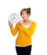 Young woman holding clock isolated on white