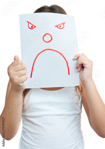 Photo: Child with a paper mask with an angry face isolated on white Child with a paper mask with an angry face isolated on white