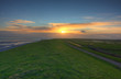 Dike in the Netherlands at sunrise Dike in the Netherlands at sunrise