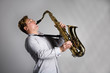 Musician plays the saxophone.