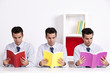 Three twin businessman reading books Three twin businessman reading books