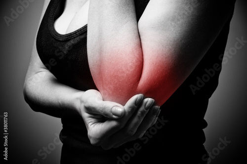 Photo: young woman having pain in her elbow young woman having pain in her elbow