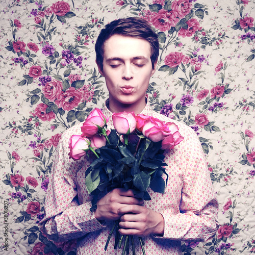 Photo: Young beautiful man with flowers Young beautiful man with flowers
