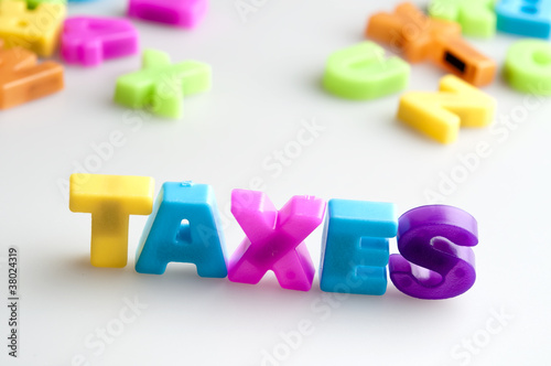 Photo: Taxes word Taxes word