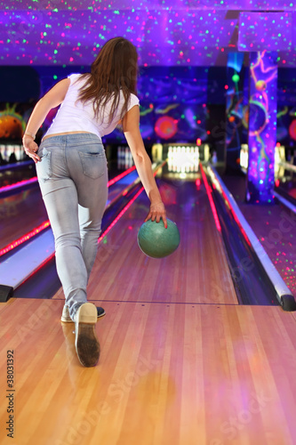 Photo: spin of girl wearing jeans making throw of green ball spin of girl wearing jeans making throw of green ball