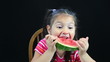Young girl eating watermelon and spitting out seed Young girl eating watermelon and spitting out seed