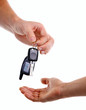 Male hand handing key over to another person