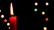 Bringing candle on background of the color lights