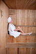 Middle aged woman enjoying a hot sauna