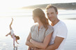 Parents and daughter on sunny beach