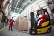 Photo: two workers loading pallets with forklift truck two workers loading pallets with forklift truck