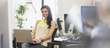 Portrait of smiling businesswoman using laptop in office