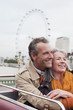 Smiling senior couple on double decker bus in London