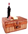 Picnic basket with wine, cheese and sausage on top