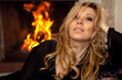 Photo: beautiful girl by the fireplace beautiful girl by the fireplace