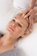 Woman having Shiatsu massage to head