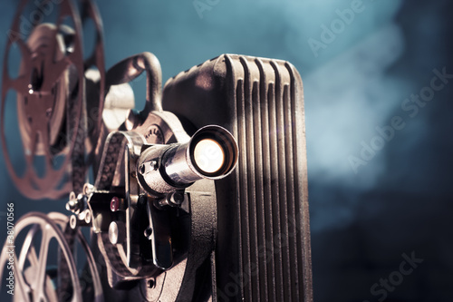 Photo: old film projector with dramatic lighting old film projector with dramatic lighting