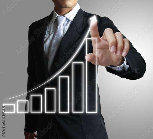 Photo: Businessman hand showing graph Businessman hand showing graph