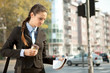 businesswoman with coffee reading newspaper