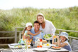 Photo: Family on vacation eating outdoors Family on vacation eating outdoors