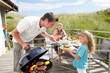 Family on vacation having barbecue