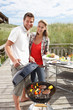 Couple on vacation having barbecue