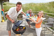Foto: Family on vacation having barbecue Family on vacation having barbecue