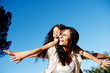 Carefree mother and child playing in the sun