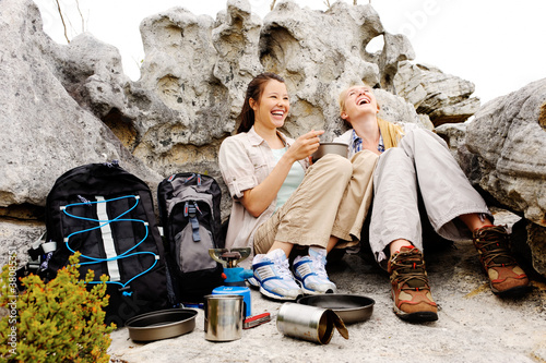 Photo: Two young hikers relaxing after a tough day hiking Two young hikers relaxing after a tough day hiking