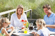 Photo: Family on vacation eating outdoors Family on vacation eating outdoors
