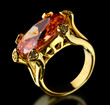 Gold ring with gem on a black