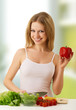 happy girl preparing vegetarian food, vegetables in the kitchen