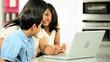 Video: Young Ethnic Mother & Children Using Laptop in Kitchen Young Ethnic Mother & Children Using Laptop in Kitchen