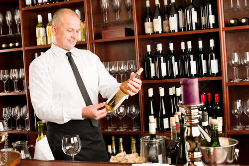 Photo: Wine bar waiter happy male in restaurant Wine bar waiter happy male in restaurant