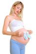 The pregnant woman holds small socks