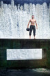 Photo: Fit man with ball on footbridge at the waterfall Fit man with ball on footbridge at the waterfall