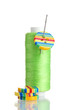 Green bobbin with needle and buttons isolated on white Green bobbin with needle and buttons isolated on white