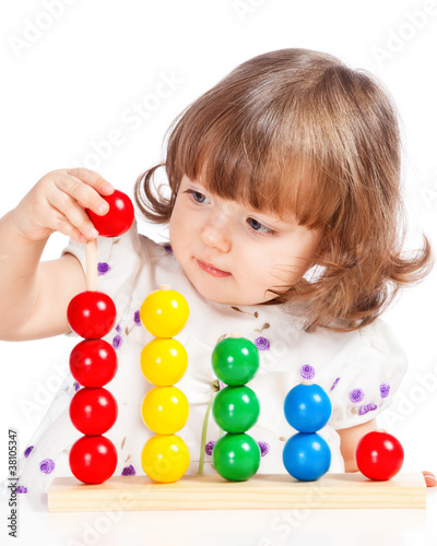 Photo: little girl playing with balls little girl playing with balls