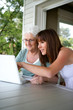 elderly woman and girl with computer